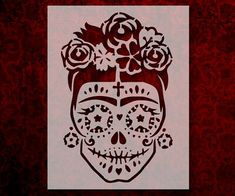 a sugar skull with roses on it's head and cross in the middle is shown