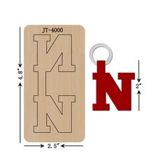 a wooden sign with the letter n on it and a metal keychain attached to it