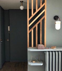 an empty room with a radiator and wooden paneling on the wall next to it