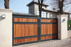 a large wooden gate in front of a house