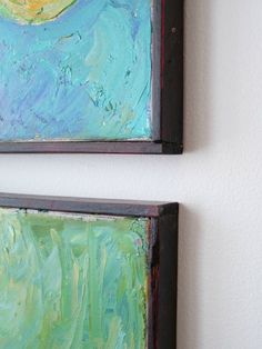 two paintings are hanging on the wall next to each other, one is blue and green