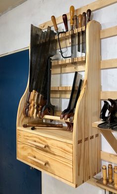 a wooden shelf with knives and other tools on it