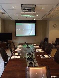 an empty conference room with a projector screen