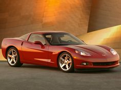 a red sports car parked in front of a building