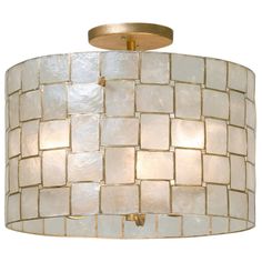 a light fixture with white tiles on it