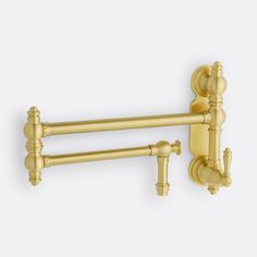 two brass - plated towel racks on a white wall, one with handles and the other without