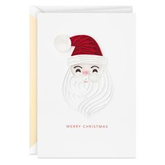 a white christmas card with a santa claus face and red knitted hat on it