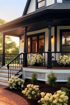 a house with white flowers on the front porch