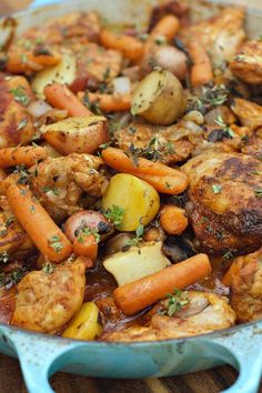 chicken, potatoes and carrots in a skillet