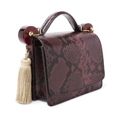 [vc_row][vc_column width=”1/3″][vc_column_text text_larger=”no”]TONYA HAWKES An inventive approach can elevate the everyday into something sublime. Lift a line, bend a curve, Luxury Chic Snake Print Shoulder Bag, Luxury Snake Print Tote Bag, Luxury Elegant Snake Print Shoulder Bag, Luxury Snake Print Evening Shoulder Bag, Luxury Brown Snake Print Bags, Snake Bag, Burgundy Fashion, Classic White Shirt, Bold Accessories