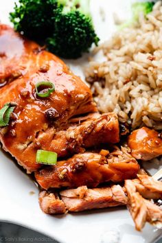 chicken, rice and broccoli on a white plate with a fork next to it