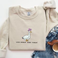 "The perfect funny cowboy vibe for a stylish silly goose! This sweatshirt is made from a soft, mid-weight cotton blend fabric for easy layering when it gets chilly, or throw it on for comfort. It makes a great gift, and we think this cozy sweatshirt has all the qualities a goose lover could ever want.  Gildan 18000 Heavy Blend Crewneck Sweatshirt Sweatshirts are unisex, classic fit.  Please refer to the size chart in the listing photos for details. Easy measuring tip: Take your favorite tee, lay it on a flat surface and measure the width (armpit to armpit) and the length (top to bottom) Recommended Care Instructions  Machine wash inside out, tumble dry low  Do not use bleach, do not dry clean  Do not iron directly on graphic  All items are made to order. They will ship within one week from Novelty Long Sleeve Cotton Tops, Novelty Cotton Long Sleeve Tops, Cotton Novelty Long Sleeve Tops, Fall Novelty Cotton Tops, Novelty Cotton Tops For Fall, Duck Sweatshirt, Western Sweater, Goose Sweatshirt, Western Sweaters