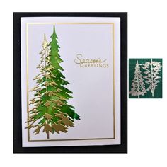 a christmas card with gold foiling and green pine trees