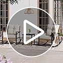 an outdoor area with tables, chairs and flowers in front of the building that has french doors