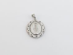 "fabulous 14k solid White Gold Virgin Mary Charm Pendant! * Material: 14k gold, Not plated or filled * Pendant Length: 1\" or 27 mm long not including the bail * Pendant Width: 7/8\" or 22 mm wide * Weight: 3.80 grams * Complementary Gift Box There is a prayer around Mary which says: O Mary conceived without sin pray for us who have recourse to thee. This Pendant is the same size as a quarter. Images may be enlarged to show detail and the item may look larger than it appears in person.In order t Commemorative White Gold Medallion Jewelry, Elegant Commemoration Jewelry With Charms, Elegant White Gold Jewelry For Commemoration, White Gold Jewelry For Commemoration, Elegant Silver Jewelry For Commemoration, Silver Miraculous Medal Round Pendant, White Gold Miraculous Medal Jewelry In Sterling Silver, Silver 14k Stamped Necklace For Commemoration, Silver 14k Stamped Necklaces For Commemoration