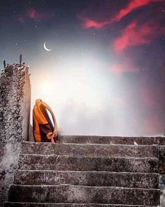 a person sitting on some steps under a cloudy sky with the moon in the distance