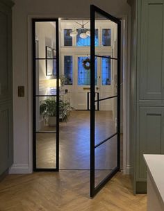 an open door leading to a kitchen and living room