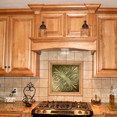 a stove top oven sitting inside of a kitchen next to wooden cupboards and counter tops