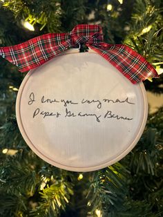 a cross stitch ornament hanging from a christmas tree with the words, you're unwrapped