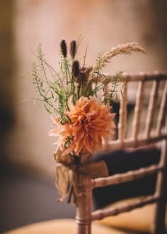 a vase filled with flowers sitting on top of a wooden chair