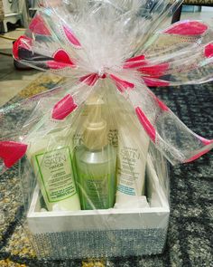 a clear gift box filled with personal care items on top of a carpeted floor