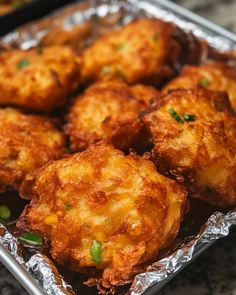 some fried food is sitting on tin foil