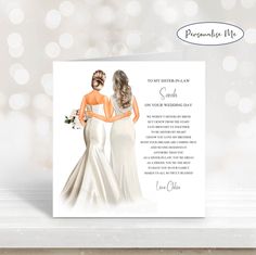 a wedding card with two women in white dresses