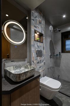 a bathroom with a toilet, sink and mirror