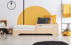 a child's bedroom with yellow and white decor, including a wooden daybed