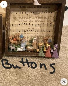 an old wooden box with musical notes and figurines in it on the floor