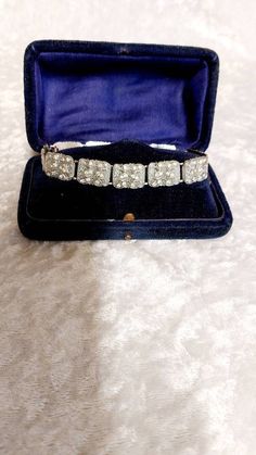 This is a gorgeous vintage Art Deco clear Diamond colour cut Rhinestone & Chromium plated bracelet c.1930-40's. This pretty bracelet measures 17cm in length and 1cm band width. The bracelet is in good condition no missing stones please read my condition definitions and use photos as a guide. Boxes are for display only and not included in the sale. The Antique boxes in the photographs are for display only and are not included in the sale. If you would like your item gift wrapped or in a modern bo Rectangular Diamond Cut Bracelet For Wedding, Rectangular Diamond Cut Wedding Bracelet, Vintage Hand Set Diamond Bracelet, Vintage Diamond Bracelet With Hand-set Diamonds, Rectangular Diamond Accent Bracelet For Wedding, Wedding Diamond Bracelet With Rectangular Accents, Wedding Diamond Bracelet With Rectangular Diamond Accents, Vintage Diamond Jubilee Bracelet, Vintage Diamond Bracelet For Anniversary