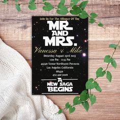 a wedding card with the words mr and mrs on it next to some greenery