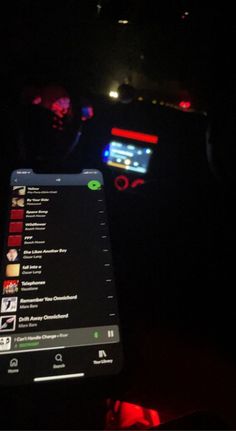 the dashboard of a car is lit up with red and blue lights in the dark