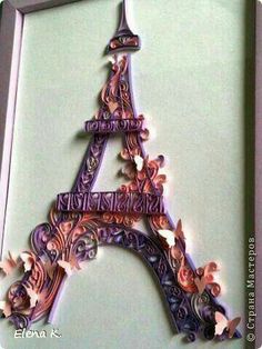 the eiffel tower is made out of paper and has flowers on it's side