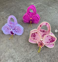 three crocheted purses sitting on the ground