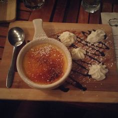 a wooden tray topped with dessert and a cup of coffee