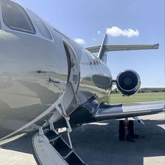 an airplane is parked on the tarmac with it's door open to let in some air