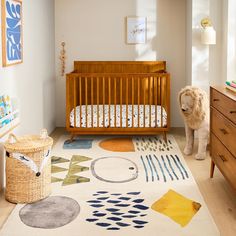 a baby's room with a crib, dresser and rug in the middle