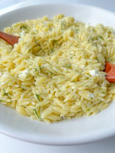 a white plate topped with pasta and cheese