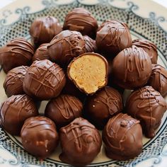 a plate full of chocolates with peanut butter in the middle and on each one