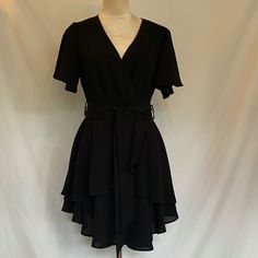 This Little Black Dress Is Perfect For Any Occasion. Short Sleeve, Flowy With Plunge Neck. Material Is Polyester Satin. Never Worn, No Tags. Ordered From Amazon. Elegant Black Flowy Mini Dress, Flowy Short Sleeve Dress For Night Out, Dressy Black Mini Dress With Short Sleeves, Flowy Short Sleeve Mini Dress For Night Out, Black Mini Dress, Polyester Satin, Dresses Black, Black Mini, Mini Black Dress