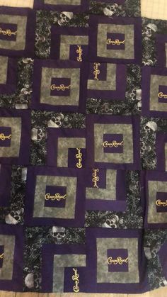 the quilt is made with purple and black squares