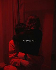 two people sitting on a bed in the dark with red light behind them and text that reads, you were red