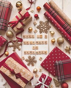 christmas presents laid out on a table with words made from scrabbles and ornaments