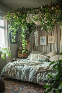 a bedroom with plants hanging from the ceiling and a bed covered in white linens