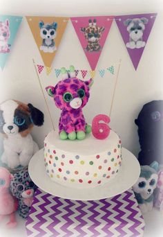 there is a birthday cake with a number six on it and two stuffed animals next to it