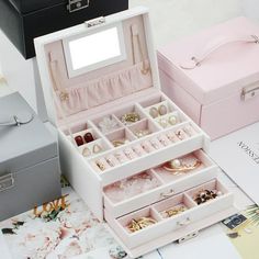 three different types of jewelry boxes sitting on top of a table