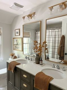 a bathroom with two sinks and mirrors in it