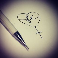 a pen is on top of a piece of paper with the word love written in it