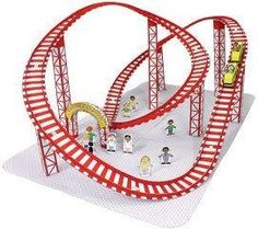 a toy train set with people riding on the tracks and around it's track